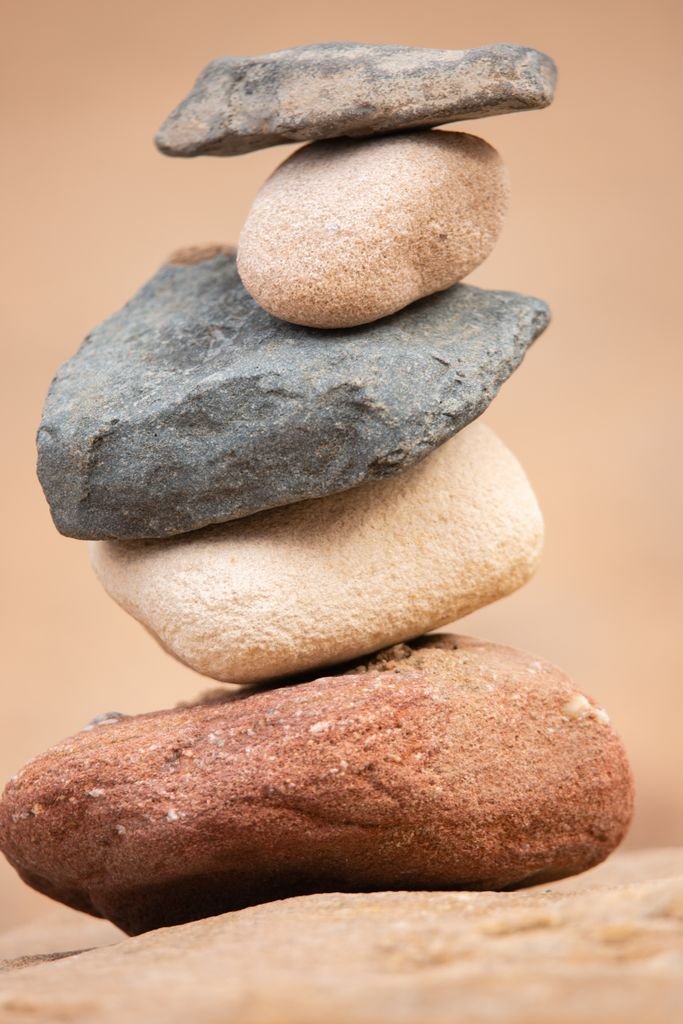 Close-up of balanced natural stones stacked in harmony, displaying texture and stability.